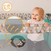 A baby is smiling and looking over the edge of a playpen. There are close-up insets showing mesh fabric and airflow. Produktbild-Vorschau