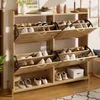 A wooden shoe cabinet with multiple shelves and doors, filled with shoes. Anteprima dell’immagine prodotto