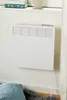 A white electric heater mounted on a wall. Náhled obrázku produktu