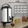 A beverage dispenser on a kitchen counter with cups and mugs. Anteprima dell’immagine prodotto