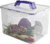 A clear plastic food storage container filled with fresh vegetables, including broccoli, red cabbage, green beans, cherry tomatoes, and baby corn. The container has a purple handle and latches. Produktbild-Vorschau