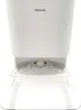 Close-up front view of the base of a white automatic vacuum cleaner and its docking station. Voir les images du produit