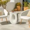 A modern outdoor seating area with two white chairs and a unique white side table. Náhled obrázku produktu