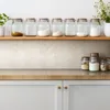 Kitchen counter with jars of ingredients on a shelf and on the counter. Produktbild-Vorschau