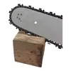 A close-up view of a chainsaw bar and chain resting on a wooden block. Produktbild-Vorschau
