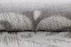 A close-up view of a folded rug with a textured pattern. Produktbild-Vorschau