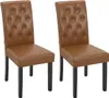 Two brown faux leather dining chairs with tufted backs and black wooden legs are shown against a white background. Produktbild-Vorschau