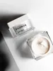 Two jars of Filorga Skin-Unify cream are displayed on a white and gray surface with dramatic lighting. Náhľad obrázku produktu