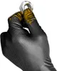 A gloved hand holding a nut. Produktbild-Vorschau