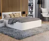 A bedroom scene with a bed, nightstand, chair, and shelving unit. Produktbild-Vorschau
