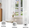 A white sheer curtain is shown hanging in a window, with a vase of tulips on a small table in front of it. Three circular icons with text are at the bottom of the image. Produktbild-Vorschau