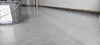 A roll of protective fleece is shown on a floor, with a portion of the roll visible and the rest unrolled. Produktbild-Vorschau