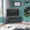 A corner TV stand with a television and other items in a room. Produktbild-Vorschau