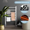 A bathroom scene featuring a white electric towel warmer with towels, a plant, and toiletries. Produktbild-Vorschau