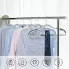 A row of clothing on hangers against a white curtain background, with icons representing clothing types at the bottom. Náhled obrázku produktu