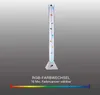 A tall, clear cylindrical lamp with small fish and bubbles inside, standing on a gray triangular base. Below the lamp is a color spectrum graphic with text. Produktbild-Vorschau