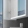A close-up view of a white bathroom cabinet with mirrored doors reflecting a snowy mountain landscape. Produktbild-Vorschau