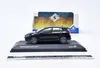 A black 1:43 scale model of a Volkswagen Golf VIII R is displayed on a black base, with its packaging in the background. Produktbild-Vorschau