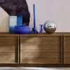Decorative items are placed on top of a wooden cabinet. Anteprima dell’immagine prodotto