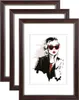 Three dark brown picture frames are stacked on top of each other, with the front frame displaying a fashion illustration of a woman wearing sunglasses. Produktbild-Vorschau