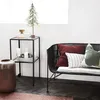 A cozy living room scene with a bench and side table decorated for the holidays. Voir les images du produit