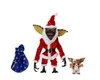 Three Gremlins figures, one dressed as Santa Claus, with a gift bag, on a white background. Produktbild-Vorschau