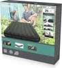 A couple is sitting near a tent with an air mattress in front of them, on a box that displays the product and its features. Náhled obrázku produktu