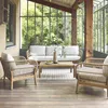 Outdoor patio furniture set on a wooden deck with a glass enclosure and greenery in the background. Produktbild-Vorschau