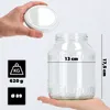 A hand holds a lid above a glass jar, with measurement indicators and weight information displayed. Podgląd zdjęcia produktu