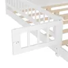 A close-up view of a white wooden bed frame, showing a safety rail with a latch mechanism. Produktbild-Vorschau