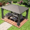 An outdoor gazebo with furniture set up on a wooden deck, surrounded by a garden. Produktbild-Vorschau