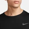Close-up of a person wearing a black Nike t-shirt. Podgląd zdjęcia produktu