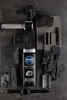 A flat lay composition of NIVEA MEN ACTIVE CLEAN 3-in-1 shower gel surrounded by charcoal pieces, a dumbbell, a watch, and other grooming accessories. Podgląd zdjęcia produktu