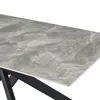 A close-up view of a table with a marble-patterned top and black metal legs. Produktbild-Vorschau