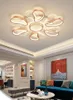 A modern living room with a large ceiling lamp, a blue sofa, and artwork on the walls. Podgląd zdjęcia produktu