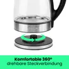Close-up of a glass electric kettle base and its power stand, with a green arrow indicating 360-degree rotation. Produktbild-Vorschau
