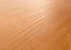 A close-up view of wood grain on a surface. Produktbild-Vorschau