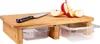 A bamboo cutting board with two clear plastic drawers underneath, holding sliced apples and a knife. Produktbild-Vorschau