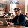 A man wearing headphones is working on a laptop in a cafe. Produktbild-Vorschau