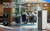 An office environment with people working at desks, and a portable air conditioner unit in the foreground. Produktbild-Vorschau