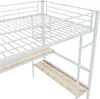 A close-up view of a white metal loft bed with wooden shelves underneath, shown against a white background. Náhled obrázku produktu