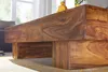 A close-up view of a wooden coffee table with a natural wood grain. Náhled obrázku produktu