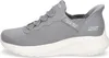 A side view of a gray Skechers slip-on sneaker with a white sole. Produktbild-Vorschau