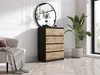 A modern bedroom or living room setting with a dresser, mirror, chair, and plant. Voir les images du produit