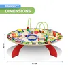 A round wooden activity table for children, featuring various interactive toys and educational elements, set against a white background. Podgląd zdjęcia produktu