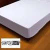 A white fitted sheet on a bed, with a logo in the bottom left corner. Produktbild-Vorschau