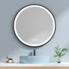 A round LED mirror is mounted above a light blue basin in a bathroom setting. Produktbild-Vorschau