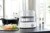 A Braun Identity Collection steamer is shown on a kitchen counter with ingredients for a healthy meal. Voir les images du produit