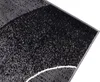 A close-up view of a rug with a modern abstract design. Náhľad obrázku produktu