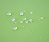 Water droplets on a green fabric surface. Podgląd zdjęcia produktu